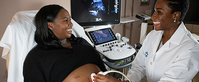 physician giving an expecting mother a sonogram