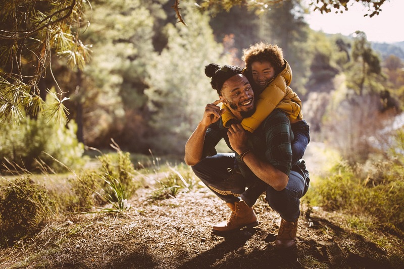 young african american male with son on back