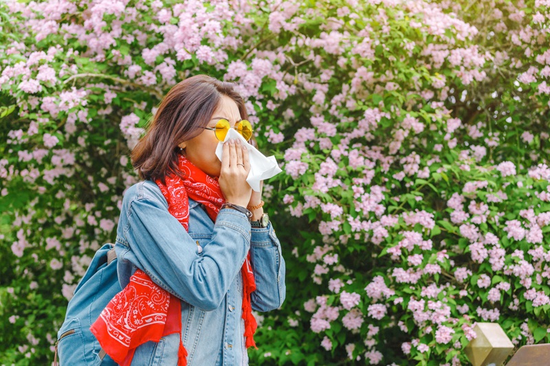 Woman blowing nose