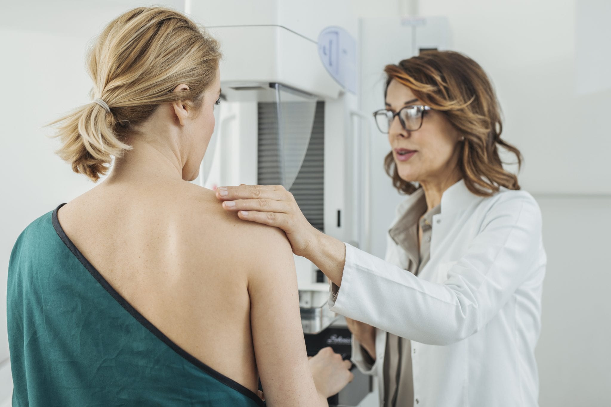 Woman In 40s Getting Mammogram with Doctor