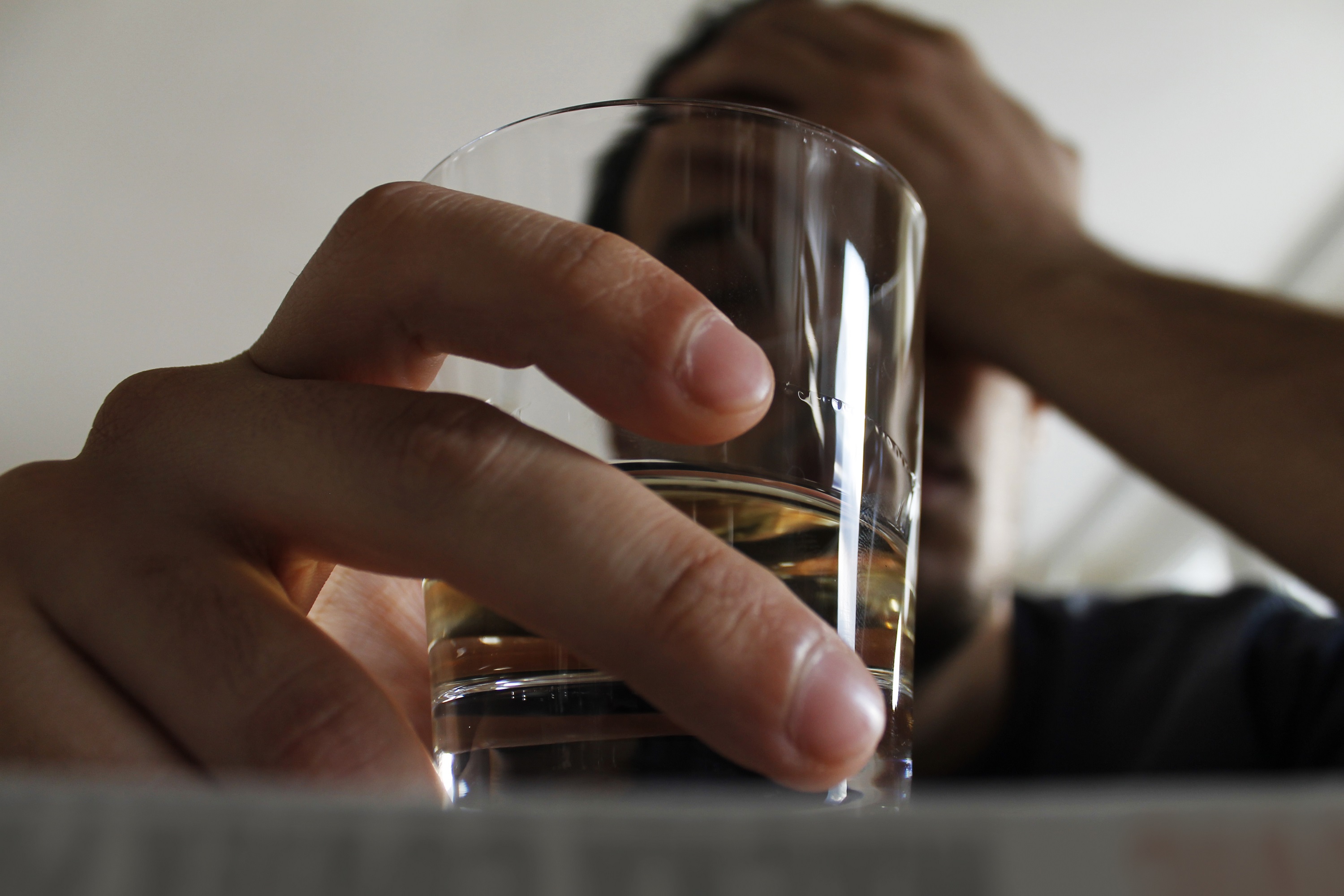 man holding shot glass