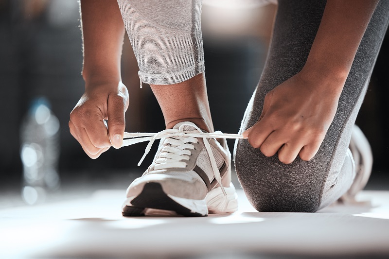 person tying a sneaker