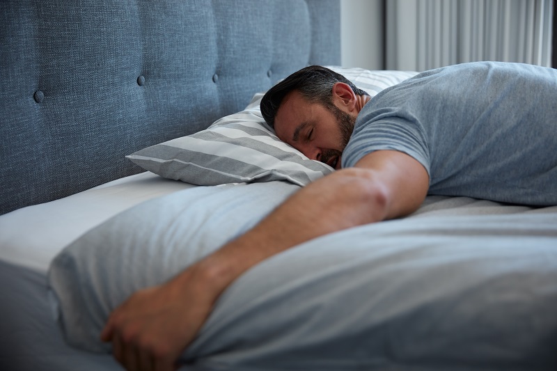 Middle aged man sleeping deeply.