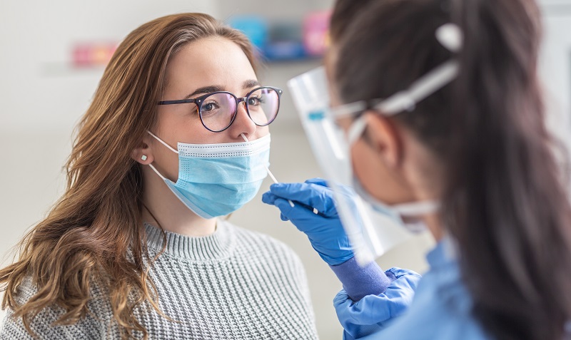 young woman gets a COVID test