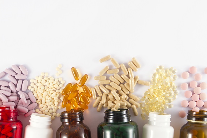 Close-up shot of medicine pills and liquid capsules for migraine.