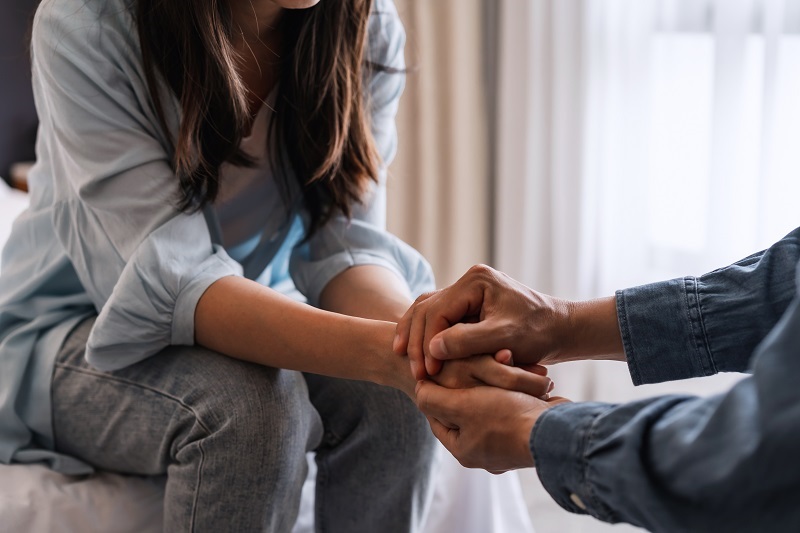Close up of partners holding hands and supporting each other.