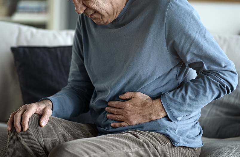 Older man with stomach pain from constipation.