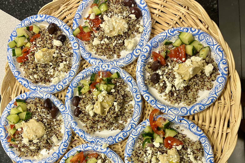 A bunch of servings of a Mediterranean grain bowl on display.