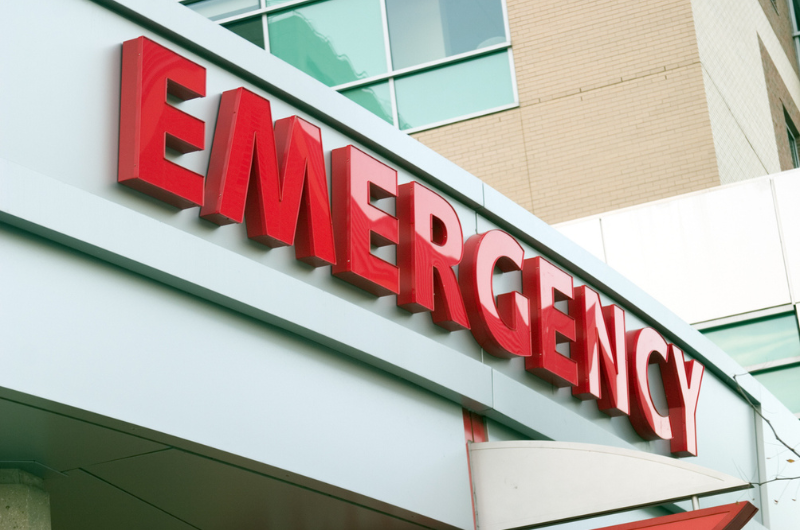 Large red emergency sign on a hospital entrance.