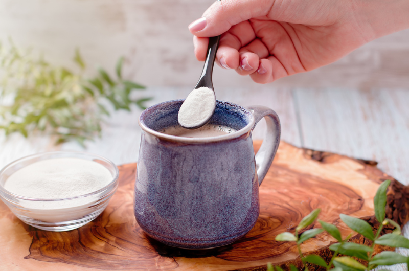 Coffee and collagen powder on a wooden board.