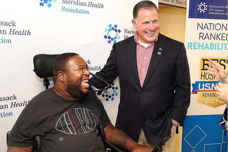 Former Rutgers football player Eric LeGrand is honored by his coach, Greg Schiano, with a generous gift to establish a new spinal cord treatment room.