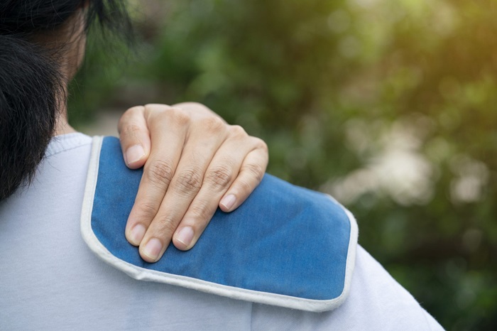 Person with icepack on shoulder