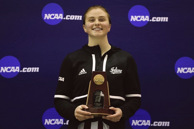A young woman, Tarrin Gilliland, receiving an award for diving.