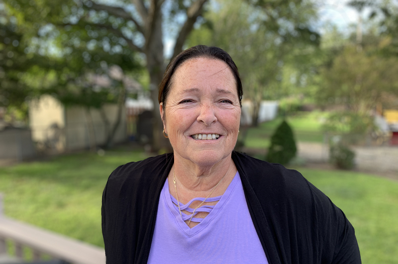 Terri Apuzzu smiling outside on a sunny day.
