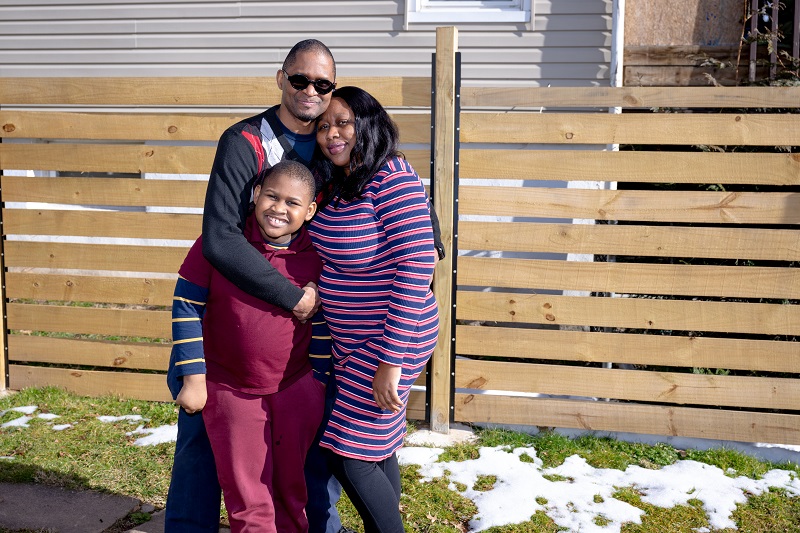 Glenn Williams smiling with his family.