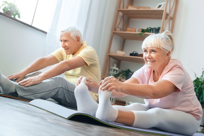 Two seniors stretching