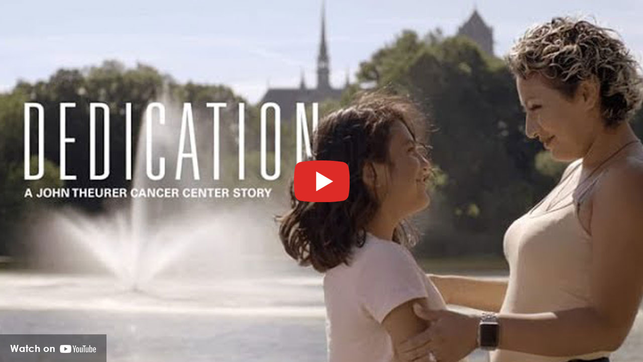 Mother and daughter embracing outdoors after breast cancer