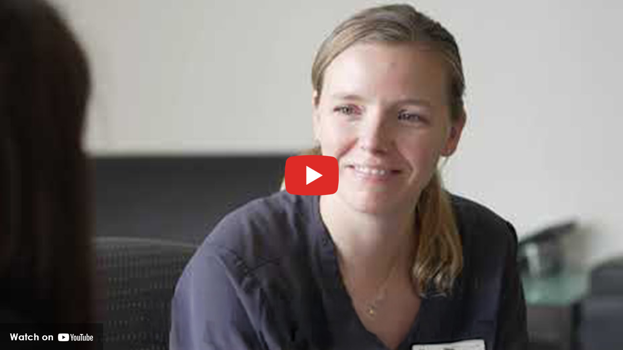 Healthcare professional smiling while talking with a patient
