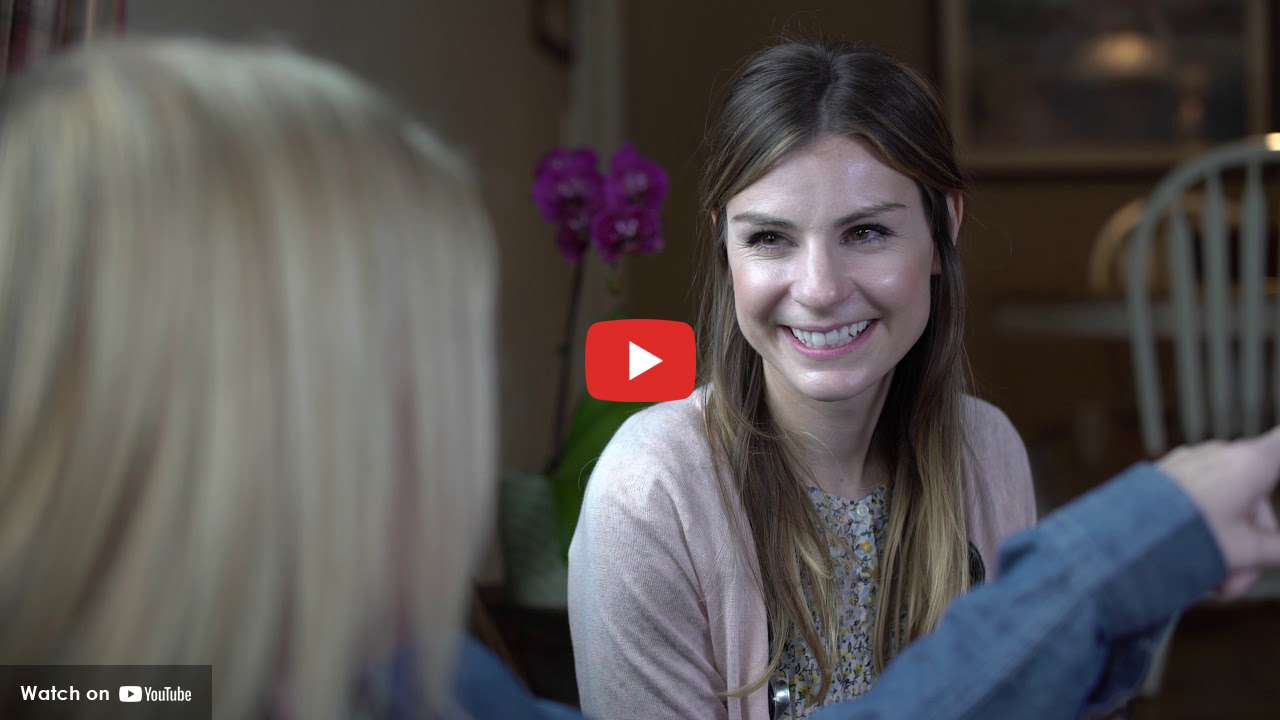 Woman smiling at another woman